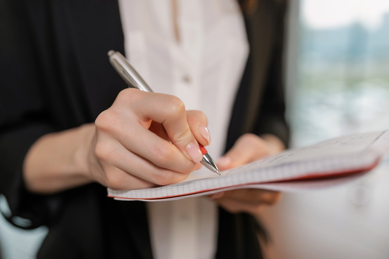 Lading writing on a notebook